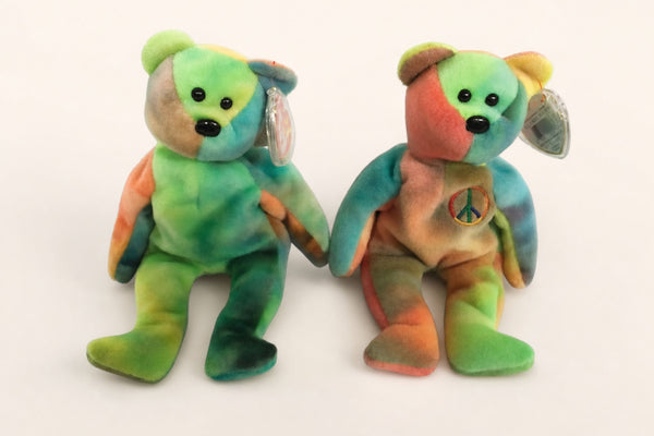 Garcia and Peace Beanie Babies side by side, the embroidered peace symbol visible on Peace's chest.