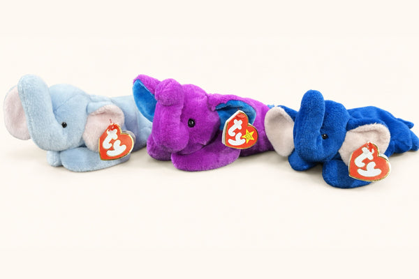 Three Ty Peanut elephants side by side: light blue, purple Peanut II, and royal blue.