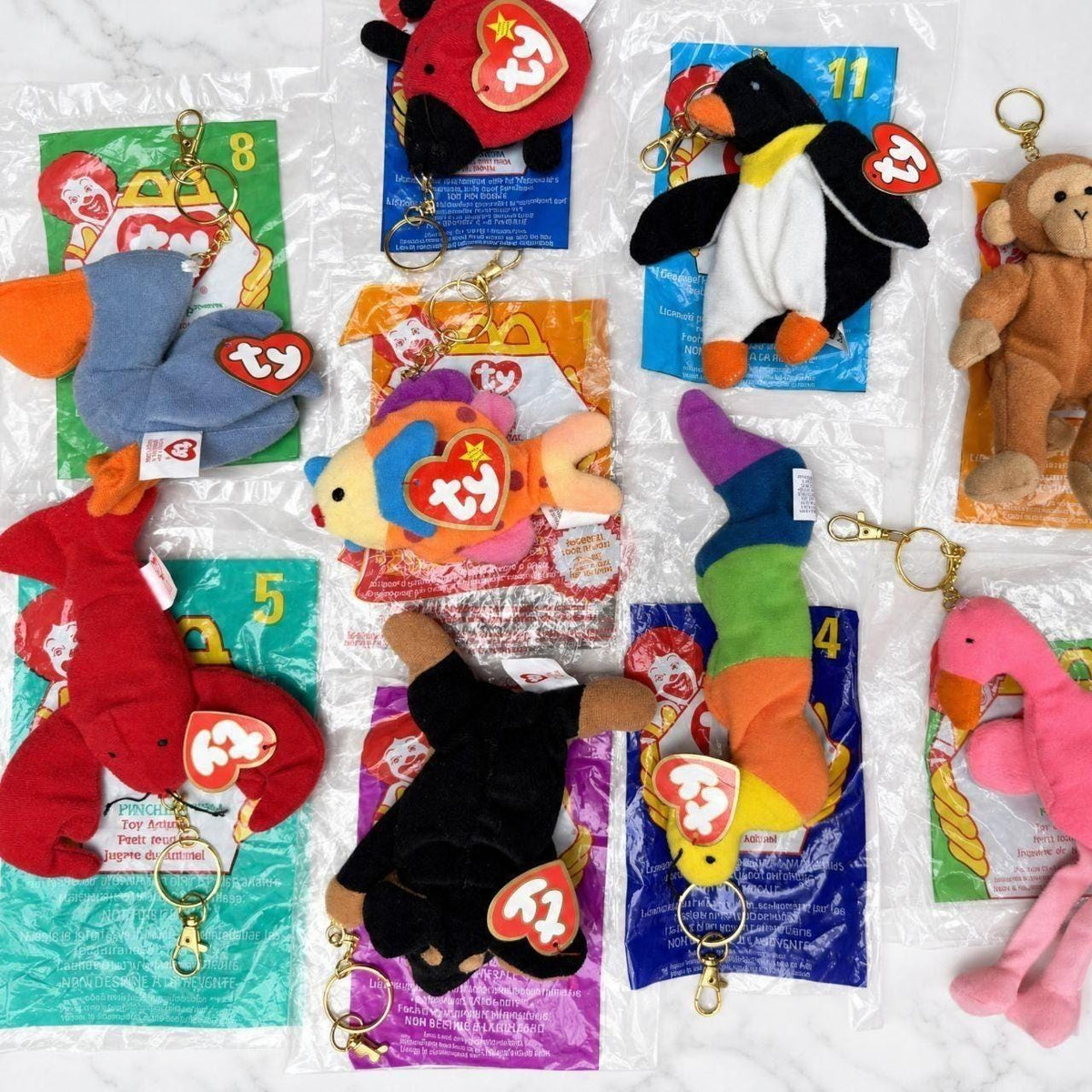 Teenie Beanie Baby bag charms with their original McDonald's Happy Meal bags