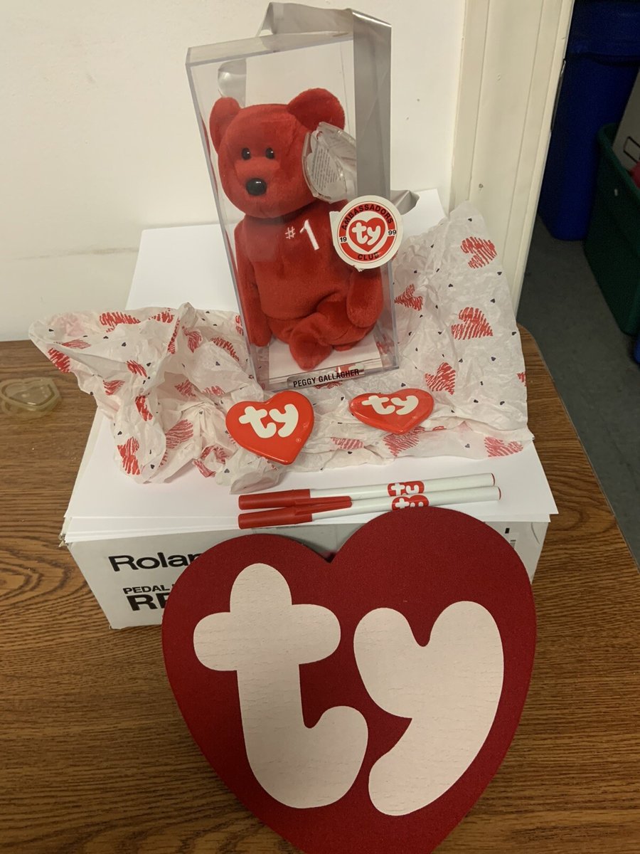 Red #1 Bear Beanie Baby in a display case, with the party gifts that came with it