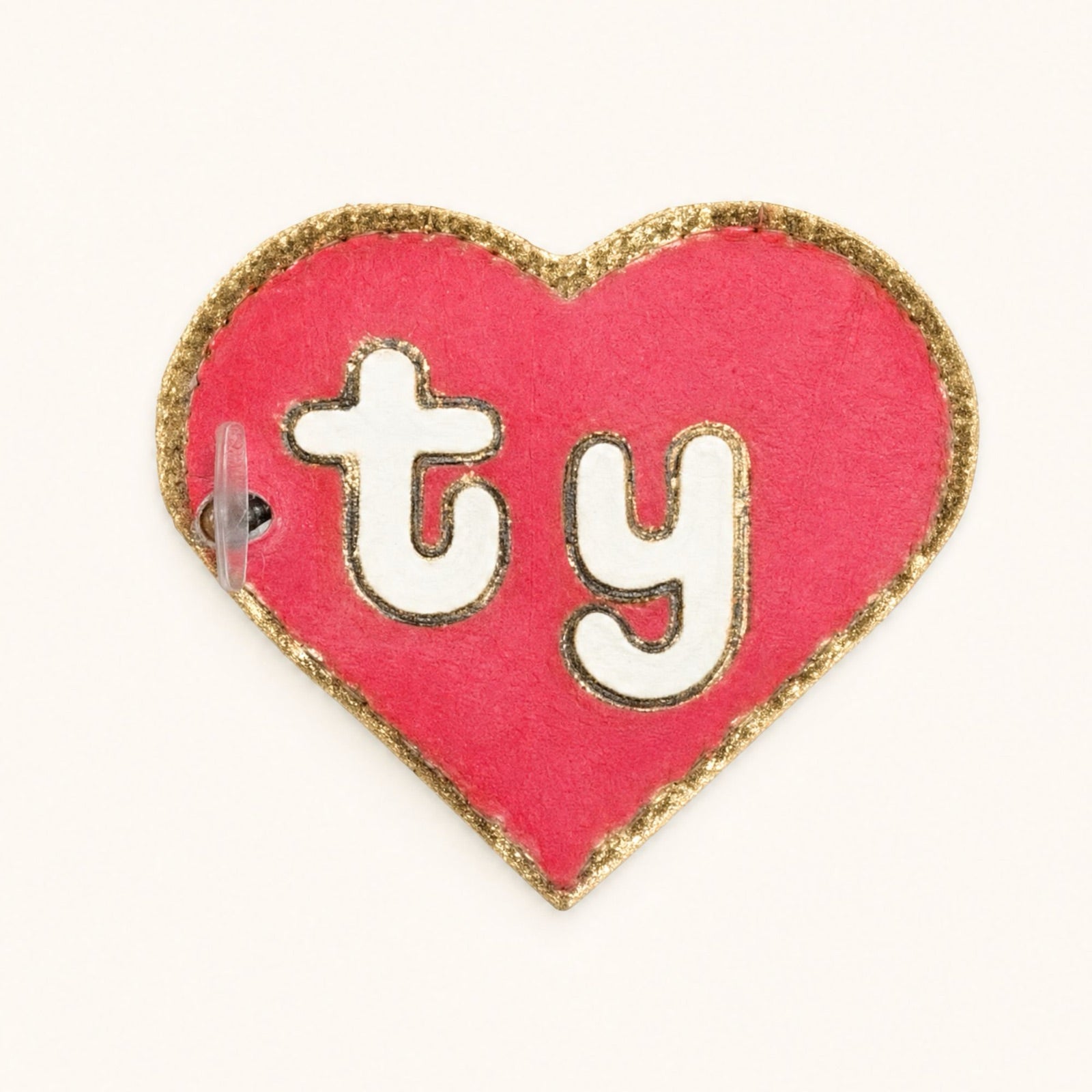 Front of a 1st generation style swing tag: a plain red heart with the skinny ty lettering and no star.